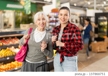 Family shopping at supermarket - choosing something in grocery section of supermarket 137868751