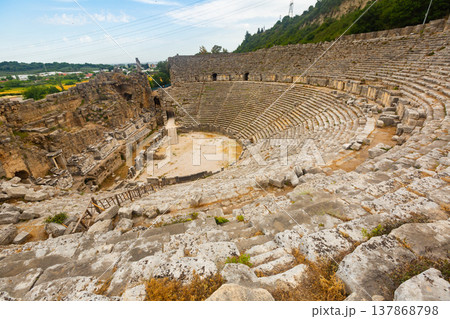 Ruins of ancient amphitheater (Theater) in Perge. Built in the Greco-Roman style, Perge is an ancient Greek city in Antalya Ruins of ancient amphitheater (Theater) in Perge. Built in the Greco-Roman style, Perge is an ancient Greek city in Antalya 137868798