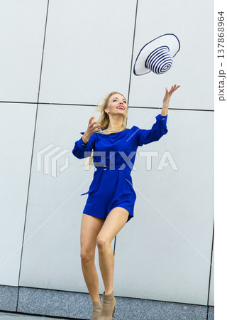 Fashion model throwing hat Fashion model throwing hat 137868964
