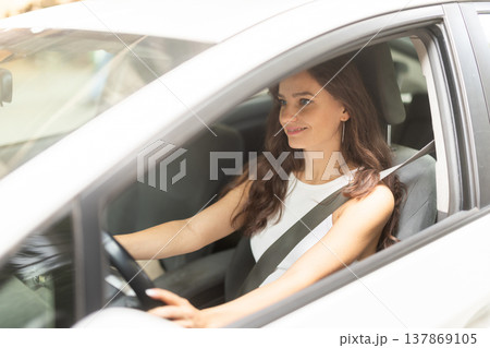 Young woman drives car in city Young woman drives car in city 137869105