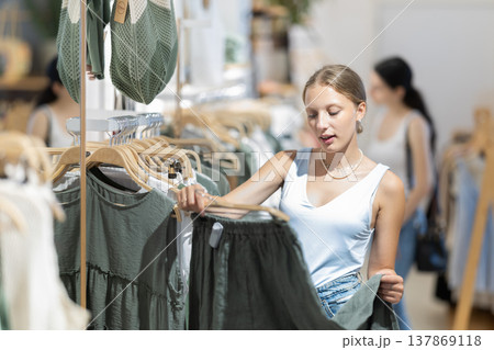 woman chooses stylish summer clothes woman chooses stylish summer clothes 137869118