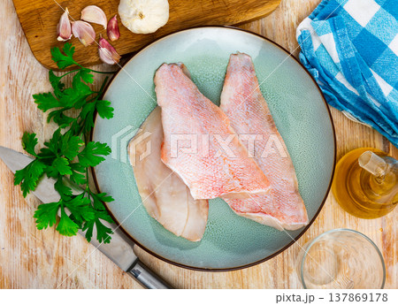 Unprepared chicken fillets on kitchen table Unprepared chicken fillets on kitchen table 137869178