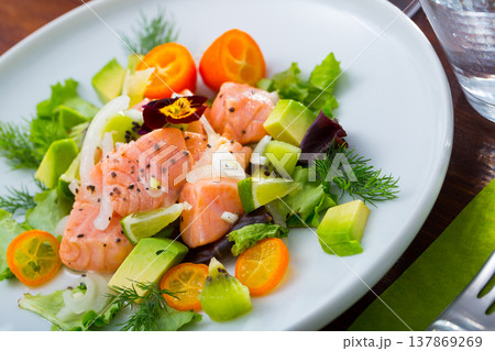 Ceviche from salmon on plate with cumquat, green dill and avocado 137869269