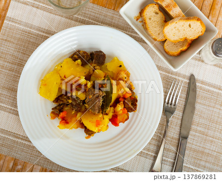 Portion of braised potatoes with beef Portion of braised potatoes with beef 137869281