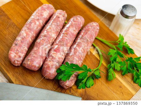 Raw botifarra from minced pork on wooden surface 137869350