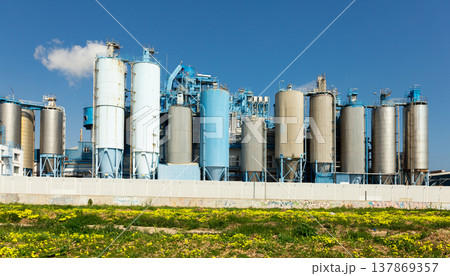 Outside view of factory with cylindrical metal constructions Outside view of factory with cylindrical metal constructions 137869357