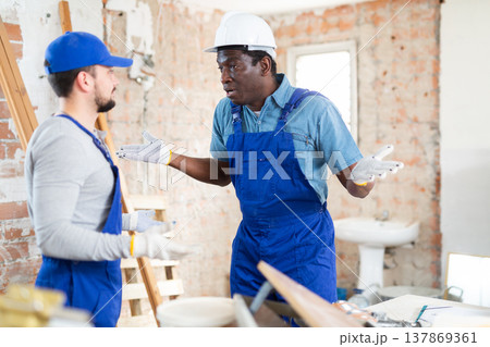 Two builders emotionally discuss working moments Two builders emotionally discuss working moments 137869361