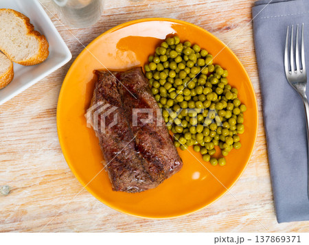 Grilled beef steak with pickled green peas on plate Grilled beef steak with pickled green peas on plate 137869371