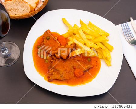 Juicy pork stew in sauce with fried potato slices Juicy pork stew in sauce with fried potato slices 137869433