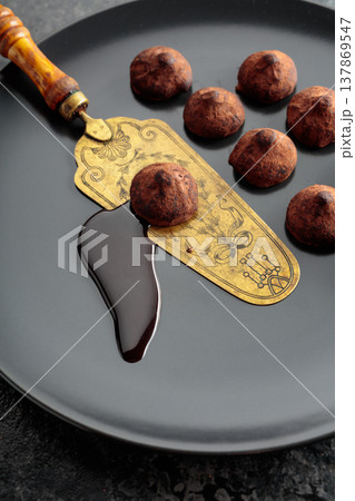 Chocolate truffles and vintage brass cake server. 137869547