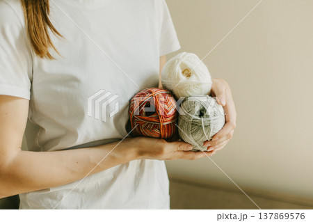 Girl with yarn skeins in a hands for knitting. Girl with yarn skeins in a hands for knitting. 137869576