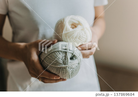 Female hands with yarn skeins for knitting. 137869684