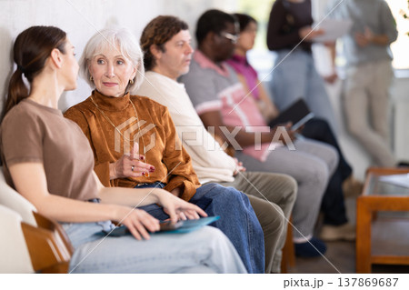 People are sitting in line and waiting for an interview People are sitting in line and waiting for an interview 137869687