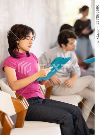 Young girl applicant sitting in a queue at a modern office 137869690