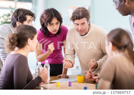 Group of people playing board game Group of people playing board game 137869757