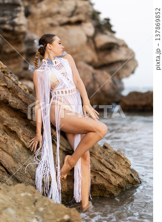 Barefoot girl on seashore in sexy and revealing Aztec carnival costume Barefoot girl on seashore in sexy and revealing Aztec carnival costume 137869852