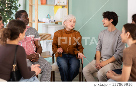 People sit in a circle and communicate in the interior of the office People sit in a circle and communicate in the interior of the office 137869916