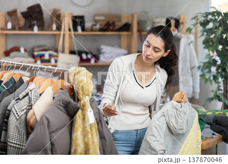 Armenian woman chooses a down jacket for autumn and winter 137870046