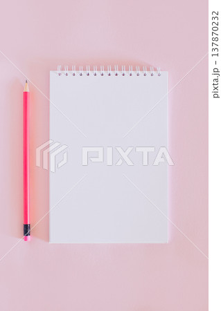 Notebook with blank page and pencil on pink background. 137870232