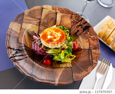 Salad with toasted goat cheese with fresh vegetables, greens, nuts Salad with toasted goat cheese with fresh vegetables, greens, nuts 137870307