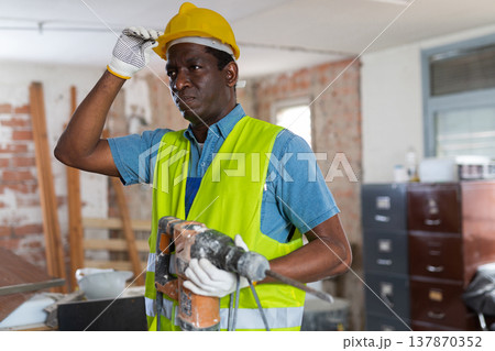 Portrait of man builder standing in construction site Portrait of man builder standing in construction site 137870352
