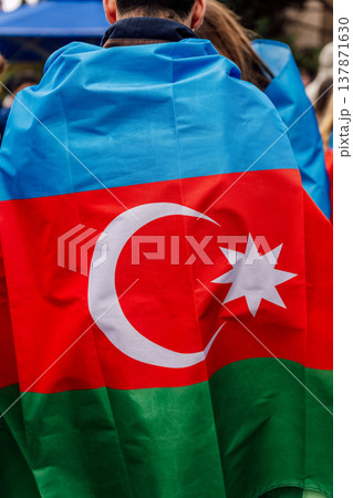 Person Wearing Azerbaijani Flag Showing Pride At Public Rally With Lively Background 137871630