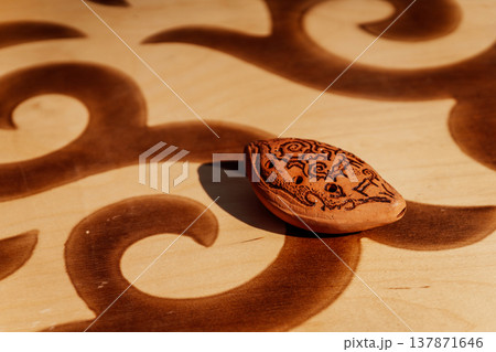 Artisan Crafted Clay Ocarina With Intricate Wood Pattern And Subtle Shadow Effects Artisan Crafted Clay Ocarina With Intricate Wood Pattern And Subtle Shadow Effects 137871646