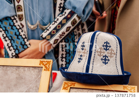 Cultural Market Scene Featuring Handcrafted Kalpak Hats With Ornate Embroidery And Vibrant Fabrics Cultural Market Scene Featuring Handcrafted Kalpak Hats With Ornate Embroidery And Vibrant Fabrics 137871758