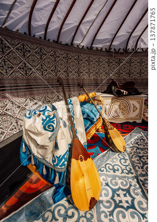 Wooden Dombra Scene. Cozy Nomadic Space With Handcrafted Decorations And Sunlit Ambiance Wooden Dombra Scene. Cozy Nomadic Space With Handcrafted Decorations And Sunlit Ambiance 137871765