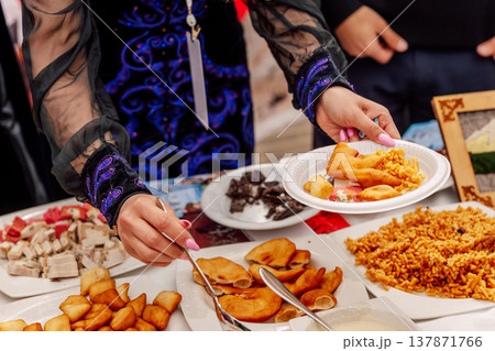 Food Sharing Scene. Community Enjoying Diverse Dishes During Lively Outdoor Festival Gathering Food Sharing Scene. Community Enjoying Diverse Dishes During Lively Outdoor Festival Gathering 137871766