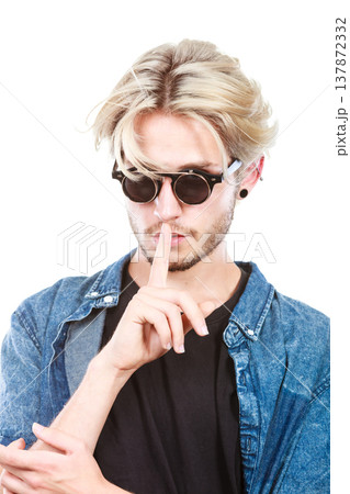 Hipster man with sunglasses making silence gesture Hipster man with sunglasses making silence gesture 137872332
