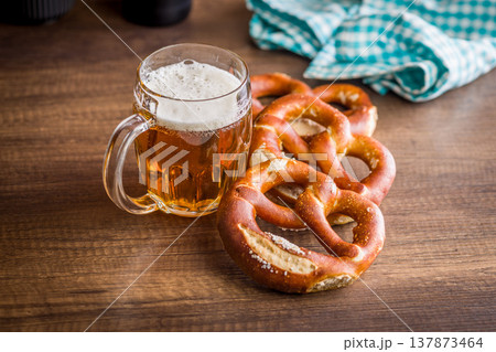 Beer Mug and Soft Pretzels on Rustic Wooden Table. Oktoberfest Snack and Bavarian Pub Food Beer Mug and Soft Pretzels on Rustic Wooden Table. Oktoberfest Snack and Bavarian Pub Food 137873464