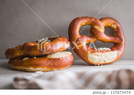 Fresh Soft Pretzels on Striped Cloth . Golden Baked Salted Snack for Breakfast or Picnic Fresh Soft Pretzels on Striped Cloth . Golden Baked Salted Snack for Breakfast or Picnic 137873474