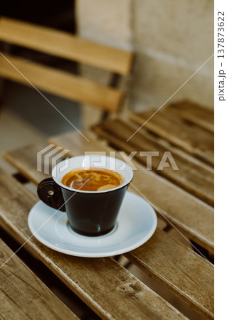 Cup of black coffee on a table in a street cafe. Cup of black coffee on a table in a street cafe. 137873622