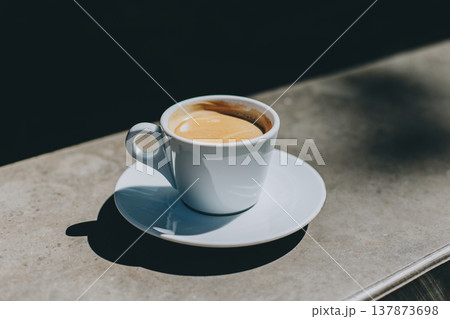 Cup of black coffee in a street cafe. Place for text. Cup of black coffee in a street cafe. Place for text. 137873698