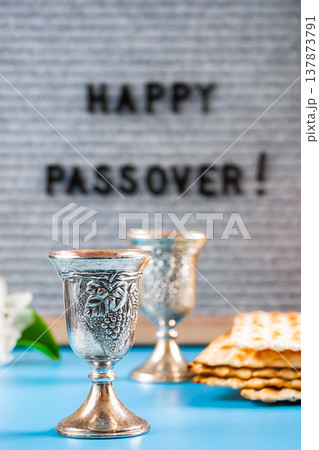 Happy Passover. Metal wine glasses and traditional Jewish matzo bread. 137873791