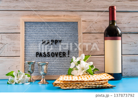 Celebrating spring holiday Passover. Bottle of wine and traditional Jewish matzo bread 137873792
