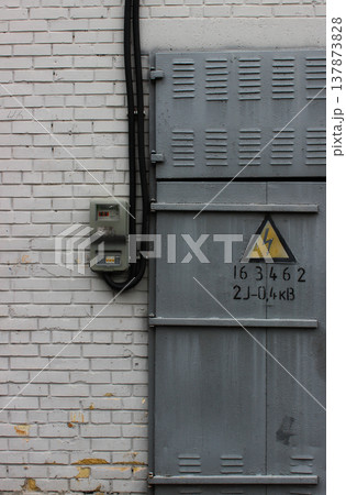 High Voltage Transformer Wall With Outdoor Electrical Panel Near Metal Door With High Voltage Risk Sign High Voltage Transformer Wall With Outdoor Electrical Panel Near Metal Door With High Voltage Risk Sign 137873828
