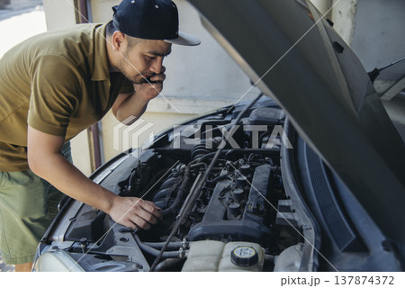 Men fix car call for help use phone calling insurance agent help fixing car problem breakdown. Man calling mechanic car service technician support fix repair driving. Vehicle emergency problem 137874372