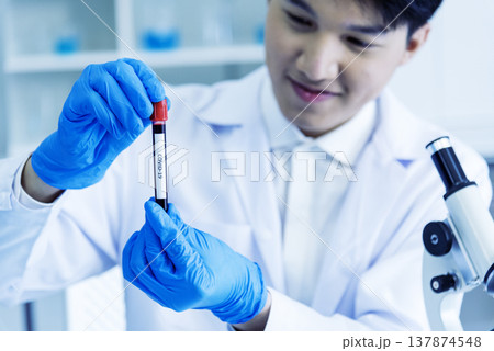 Close up Scientist man hands holding sample blood test tube science laboratory. Doctor clinic healthcare technician lab testing blood sample diagnosis. Crop man scientist hands testing medical lab Close up Scientist man hands holding sample blood test tube science laboratory. Doctor clinic healthcare technician lab testing blood sample diagnosis. Crop man scientist hands testing medical lab 137874548