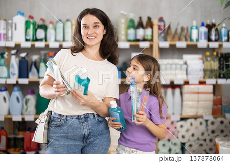 Mom and daughter choose a dental care kit Mom and daughter choose a dental care kit 137878064
