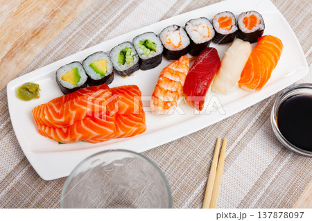 On table there portion set with maki, sashimi and nigiri On table there portion set with maki, sashimi and nigiri 137878097