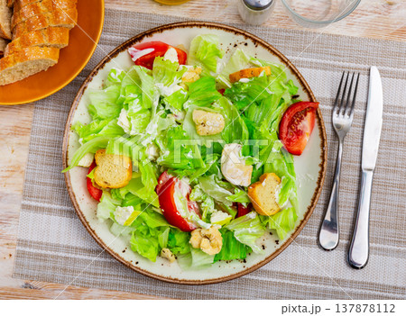 Portion of fresh Caesar salad with tomatoes Portion of fresh Caesar salad with tomatoes 137878112