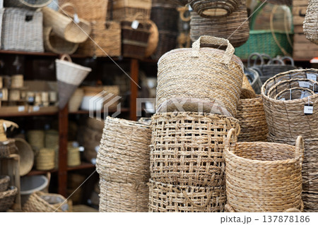 Stack pile of wicker baskets, large and small, stand on top of each other in store Stack pile of wicker baskets, large and small, stand on top of each other in store 137878186