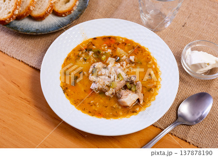 National Russian dish is Pickle soup with meat, cooked on basis of pickled cucumbers and pearl barley 137878190