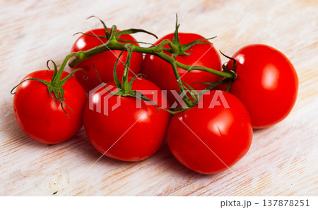 Close up of ripe red tomatoes on wooden surface Close up of ripe red tomatoes on wooden surface 137878251