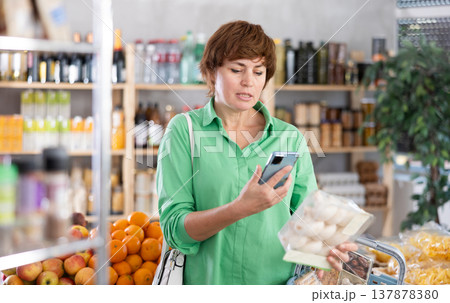 Adult woman scanning qr code of champignons Adult woman scanning qr code of champignons 137878380