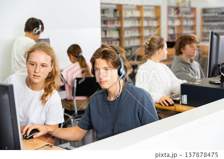 Teenager girls and boys studying in computer lab 137878475