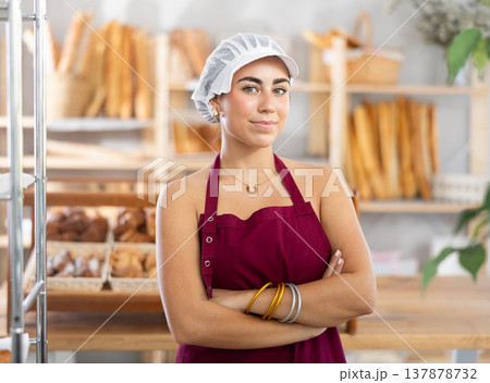 Young female seller posing in bakery Young female seller posing in bakery 137878732