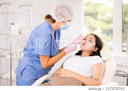 Doctor doing anti-aging beauty procedures 137878741